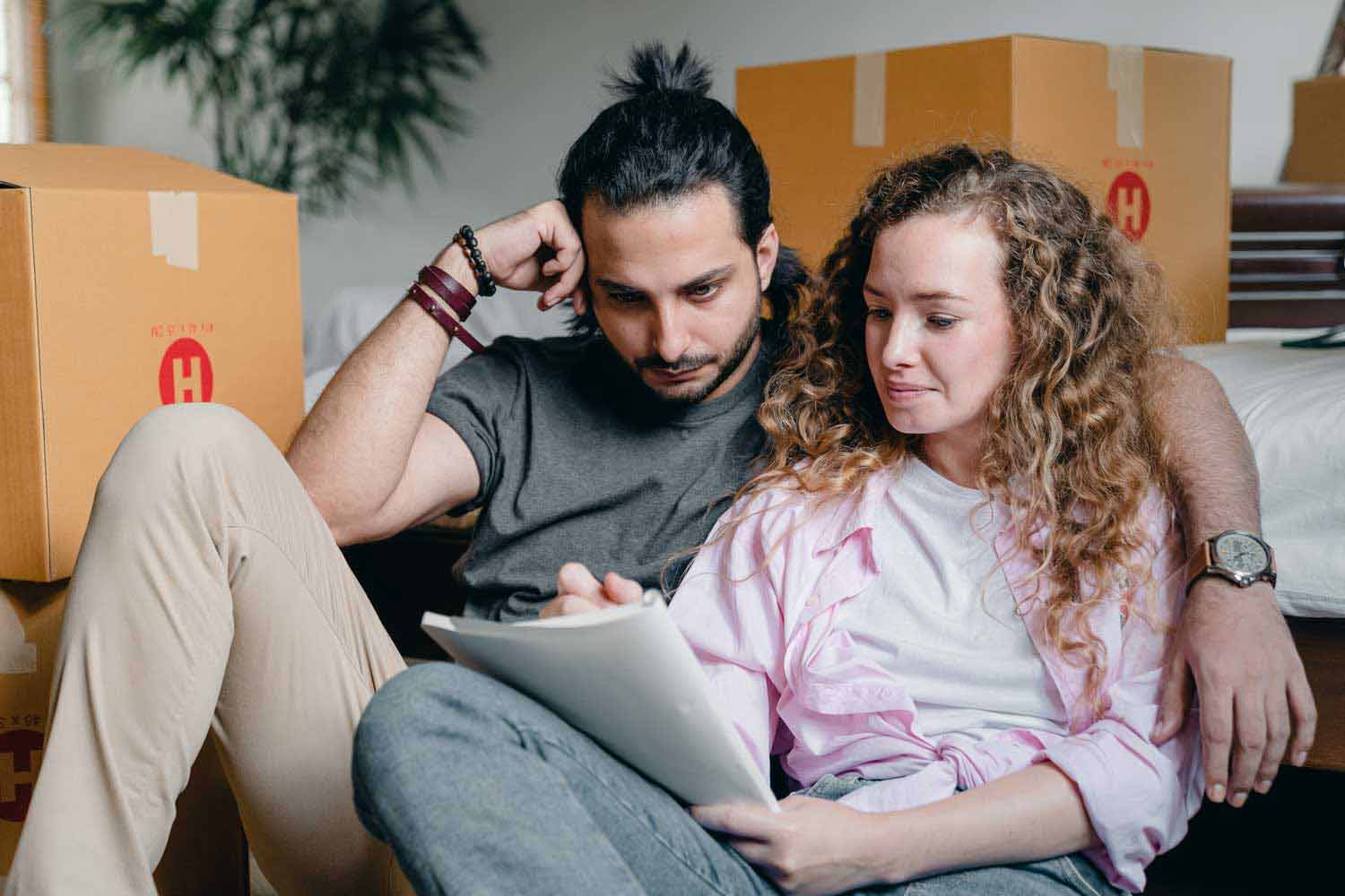 Young couple completing checklist loan processor