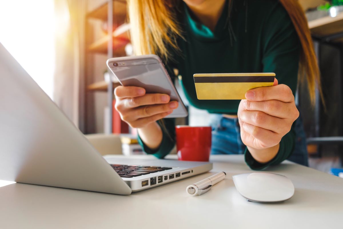 Person holding phone and credit card