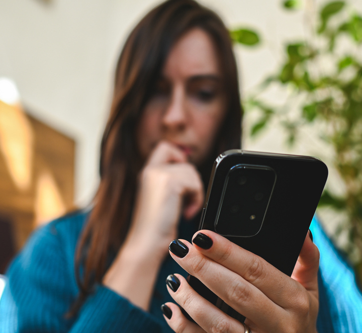scared lady looking at her phone