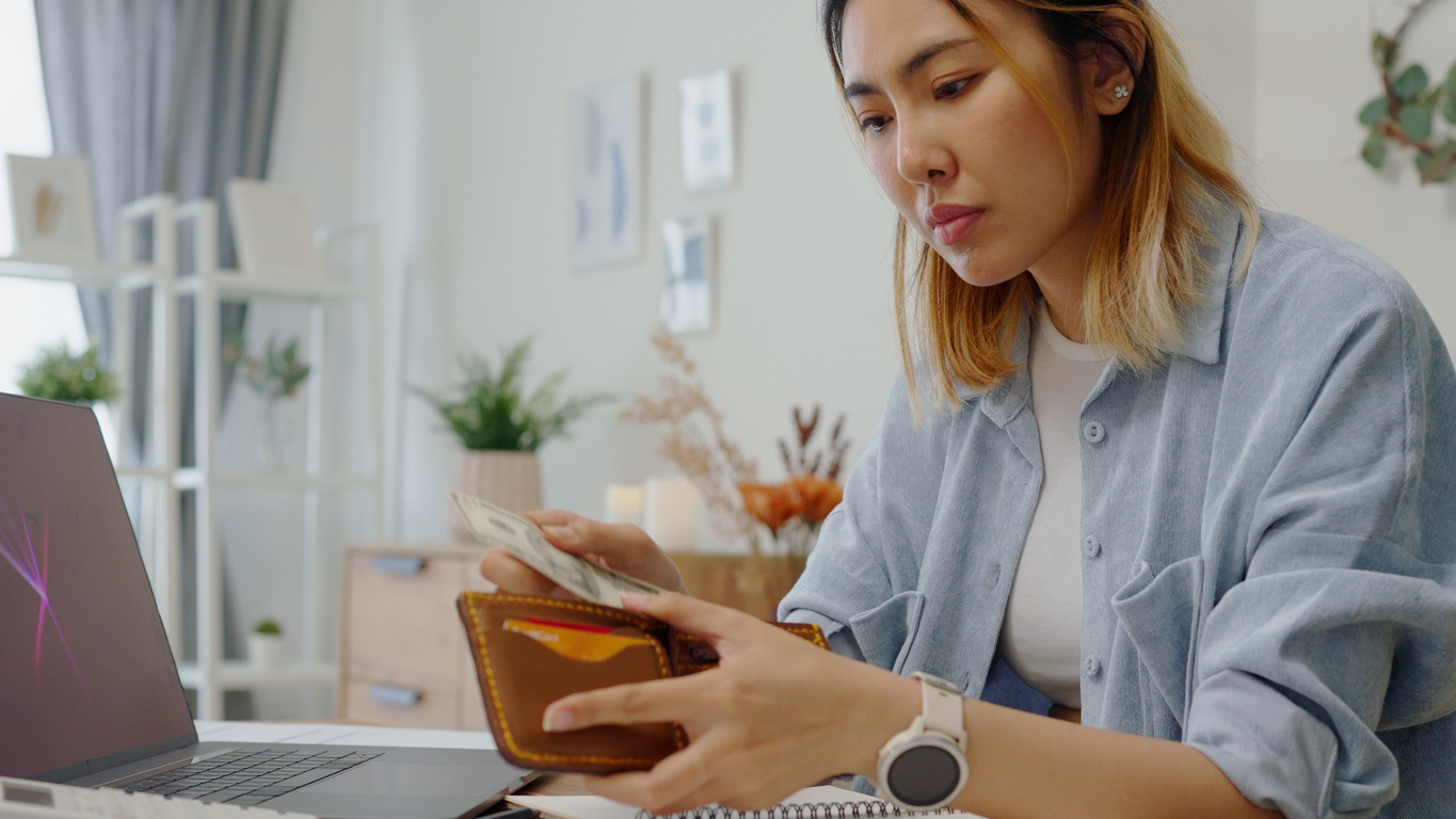 woman taking money out of a wallet