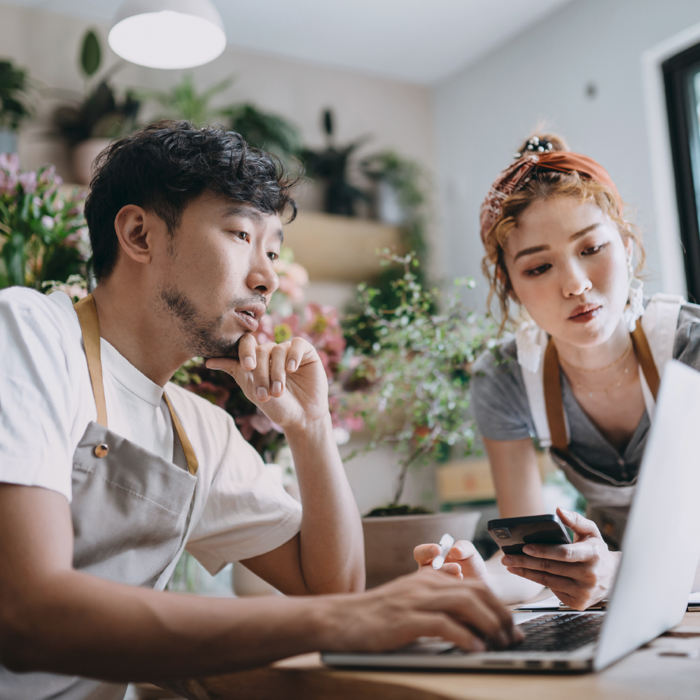 two people looking at a laptop