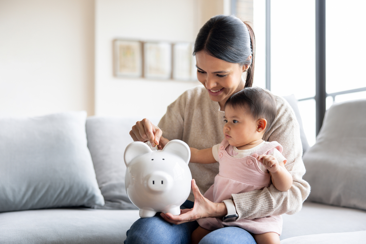 A woman sitting with a baby on her lap