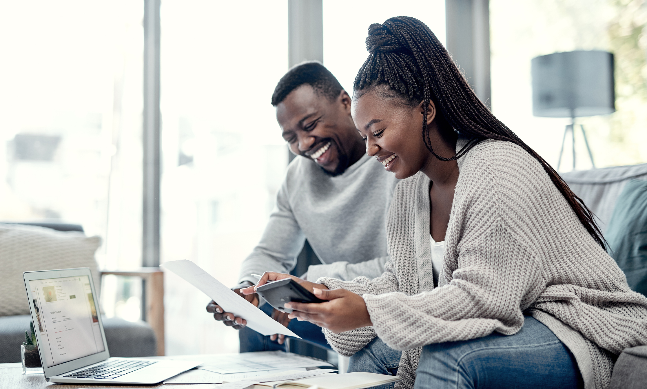 Shot of a young couple going through paperwork at home