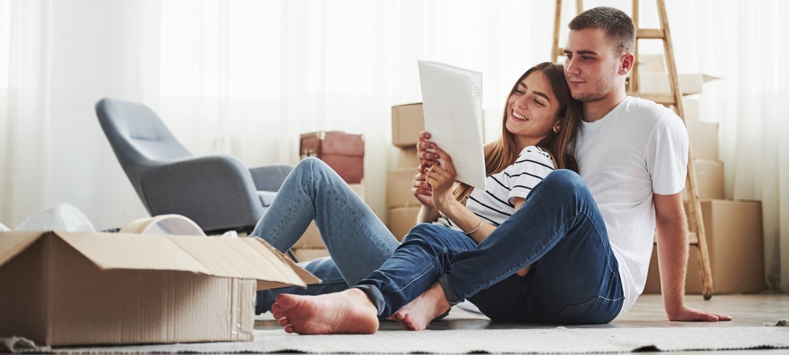 Couple unpacking boxes and reading instructions
