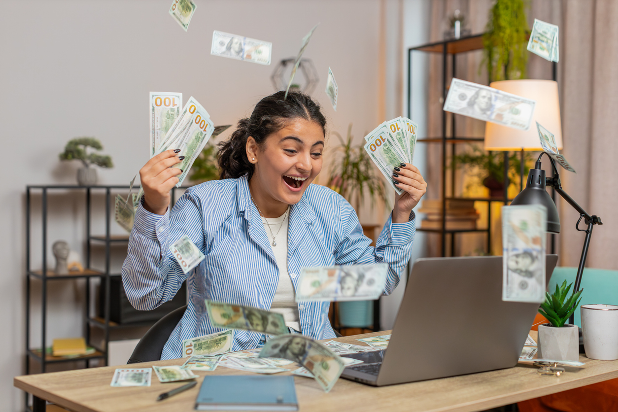 A happy woman holding money