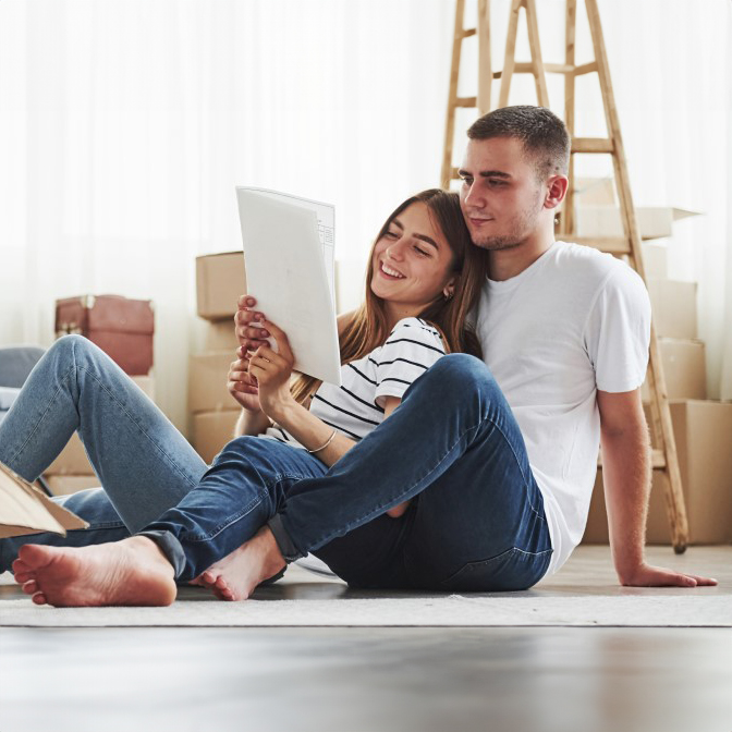 Couple unpacking boxes and reading instructions