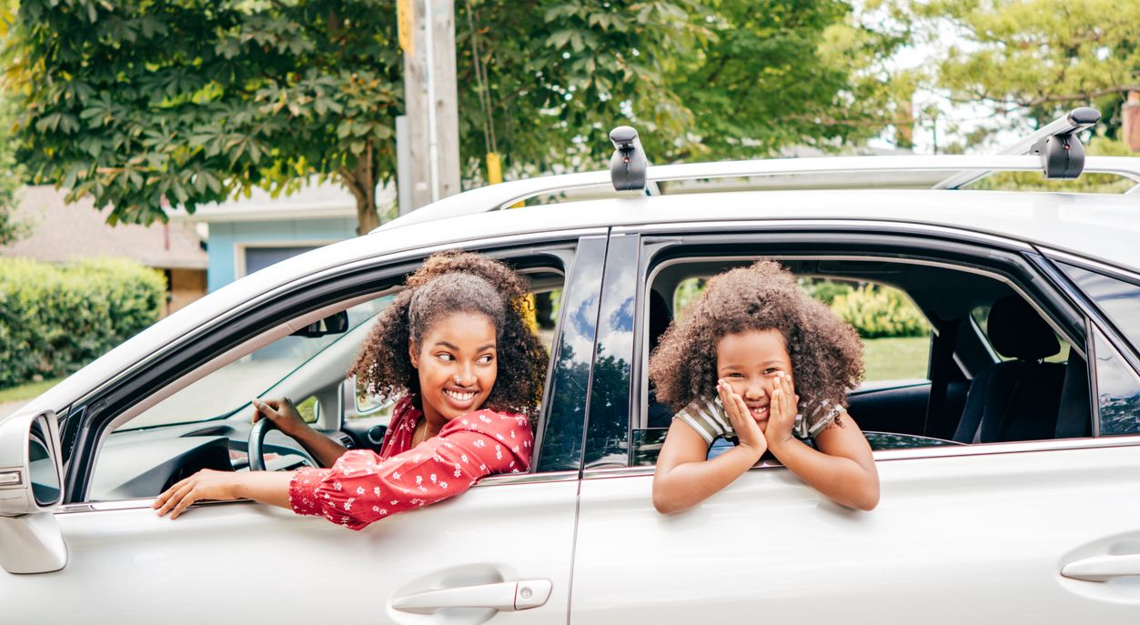 mom and daughter driving in car