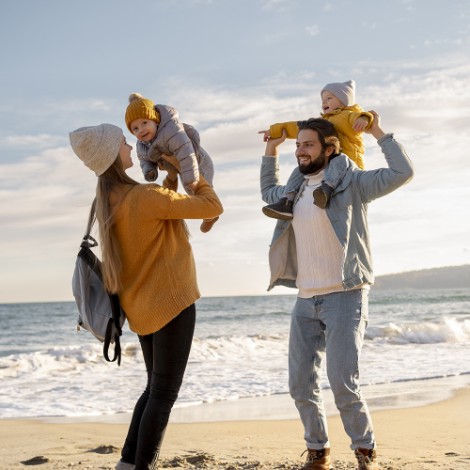 Family running to the beach