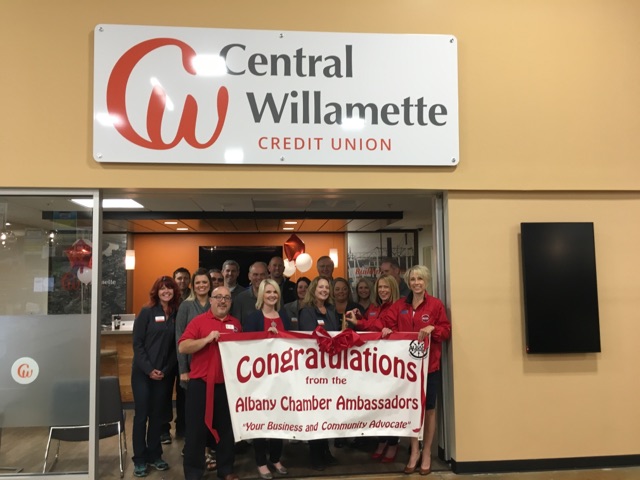 Team members posing in front of bank