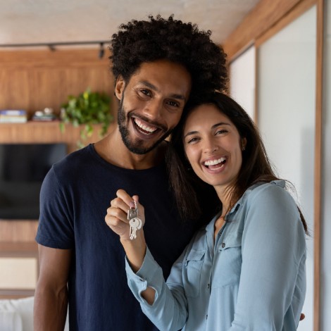 Couple smiling and holding a key