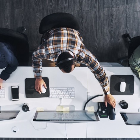 Three people working in an office