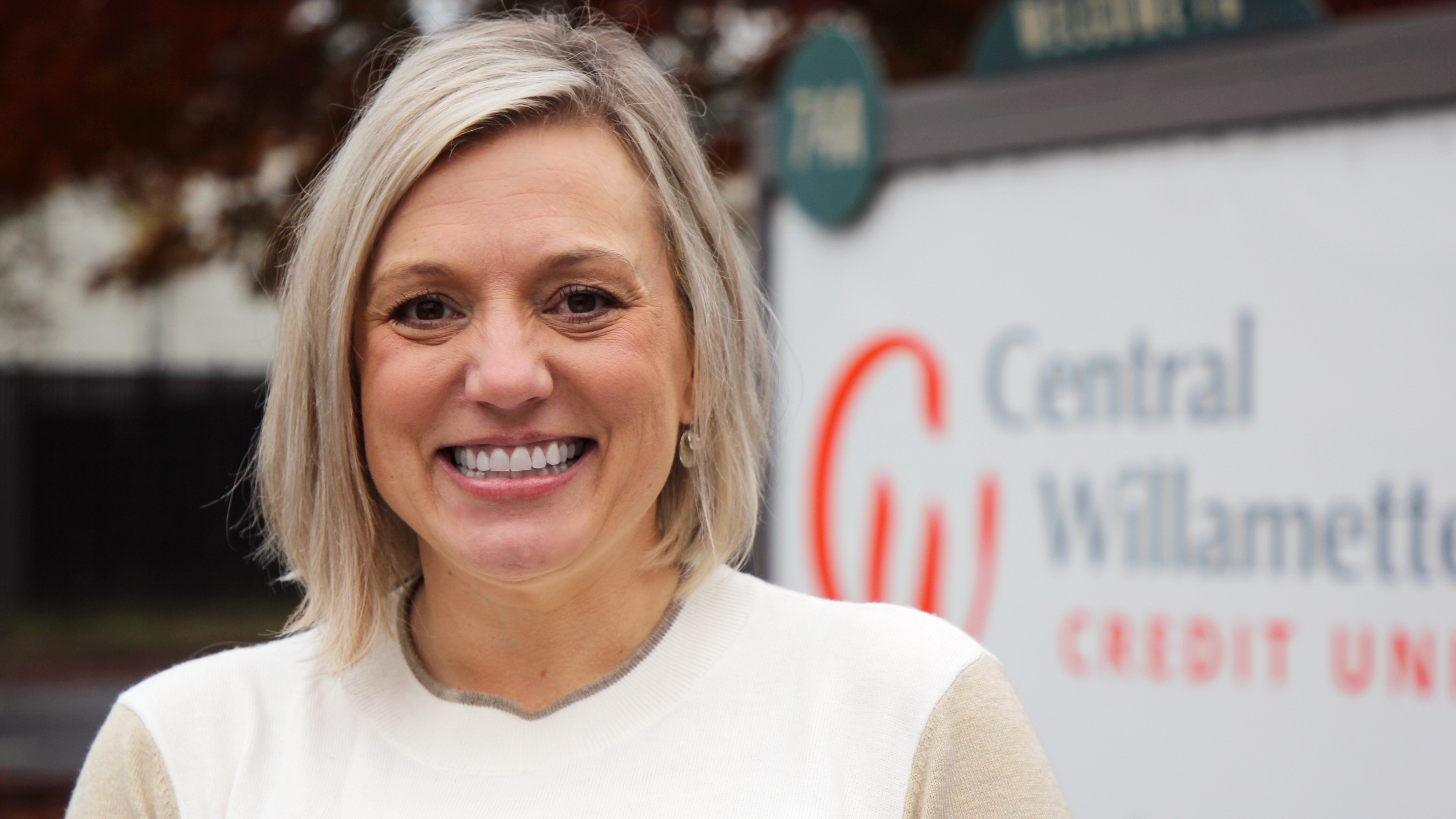Kellie in front of sign
