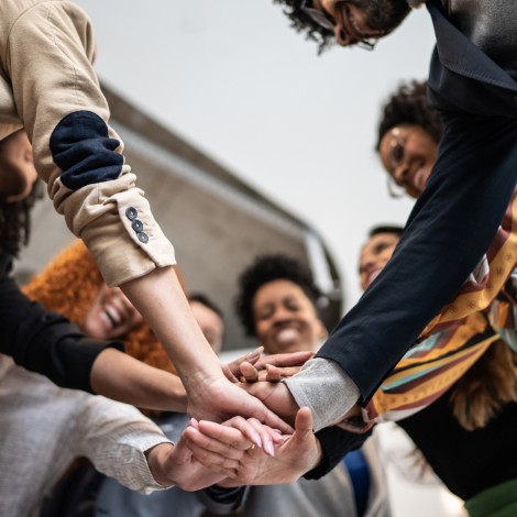 Team of coworkers with hands in a circle
