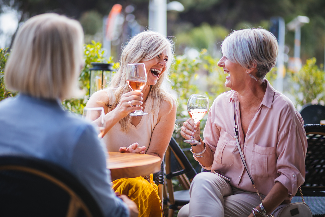 3 ladies enjoying a glass of wine outside