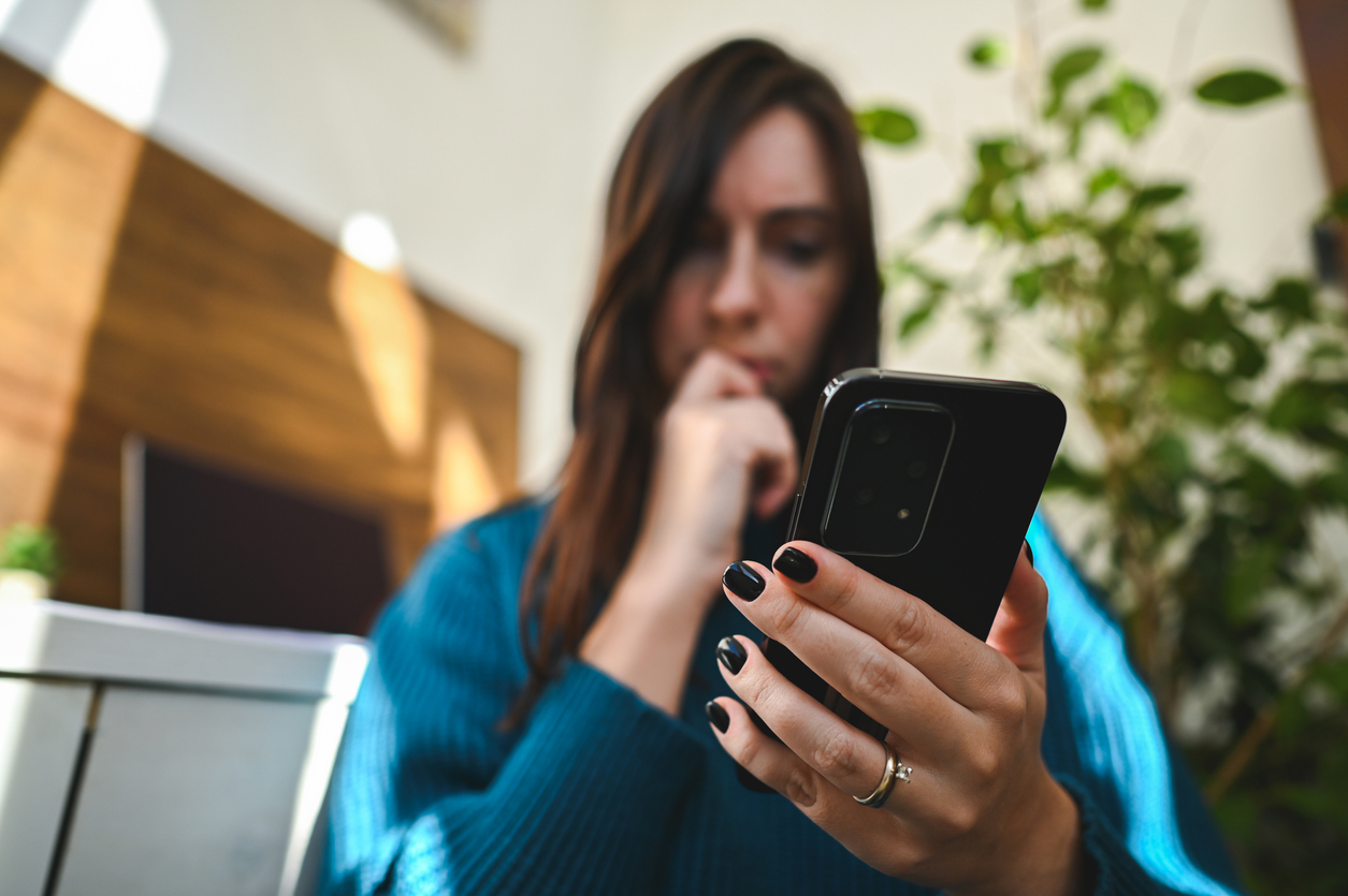 Scared lady looking at her phone