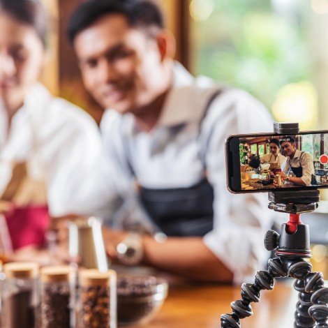 Two men making coffee and recording it