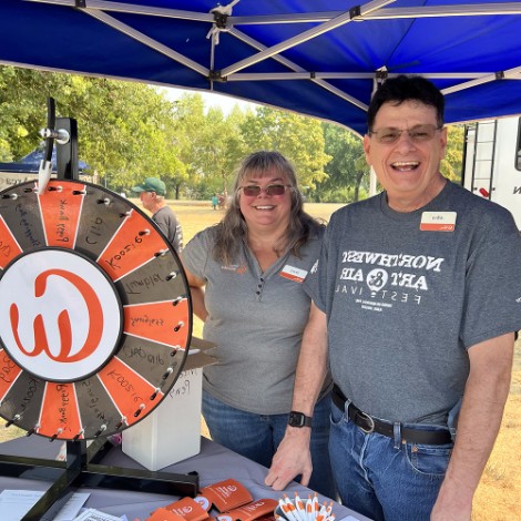 Man and woman spinning CWCU wheel