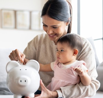 A woman sitting with a baby on her lap
