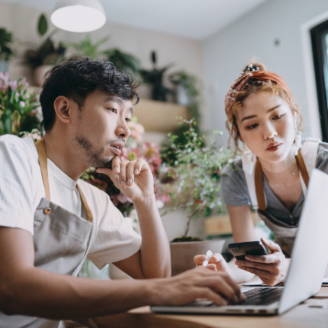 two people looking at a laptop