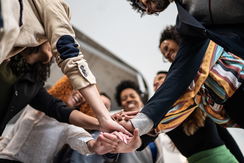 Team of coworkers with hands in a circle