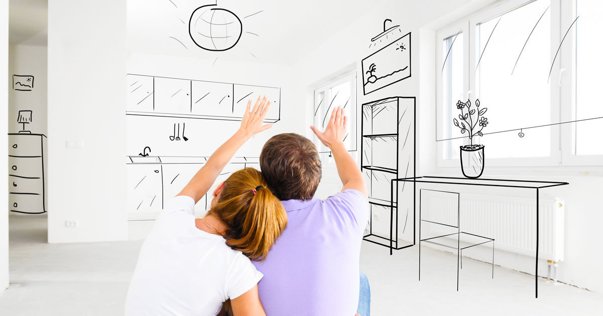 Couple sitting looking at blueprints