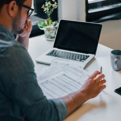 Man with documents and laptop