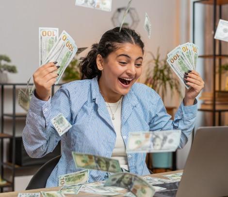 A happy woman holding money