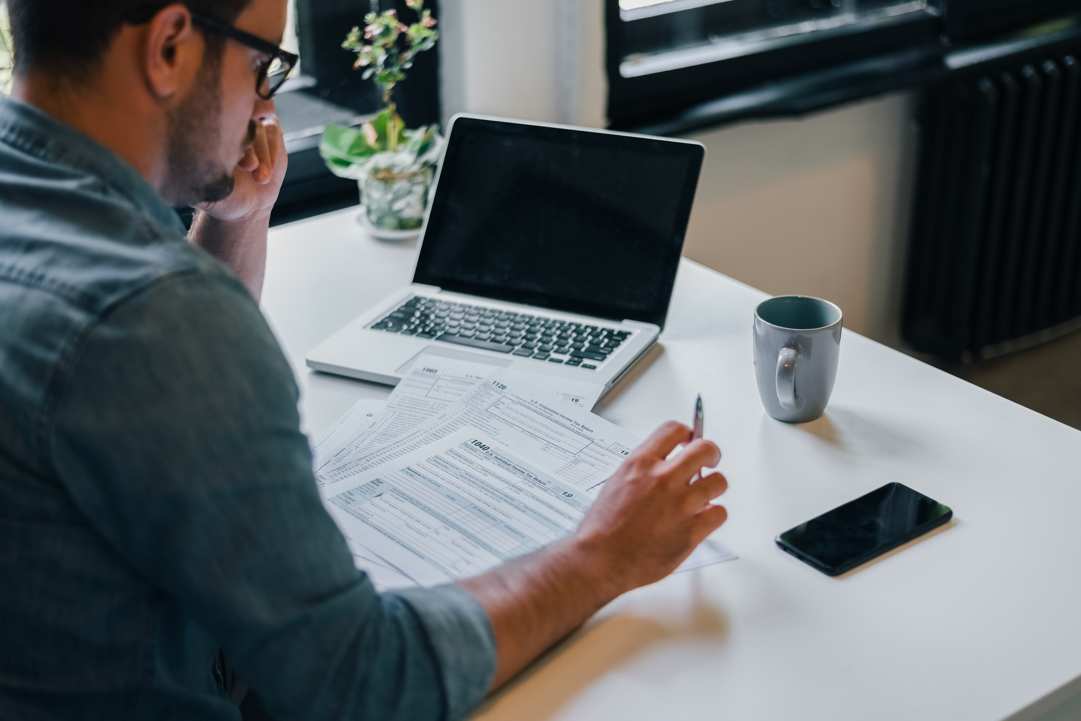 Man with documents and laptop
