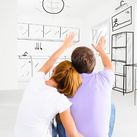 Couple sitting looking at blueprints