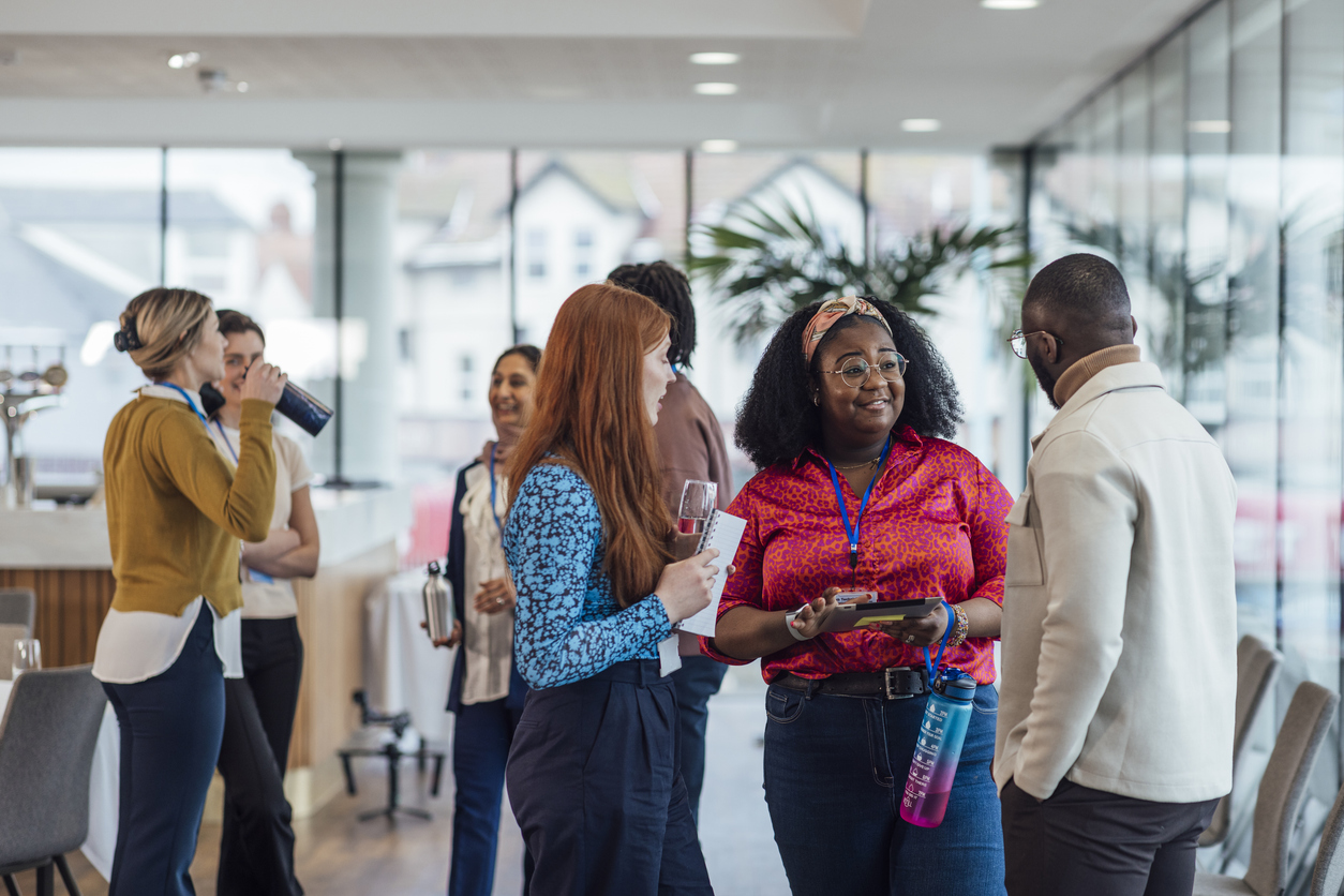 A group of business professionals standing up and networking