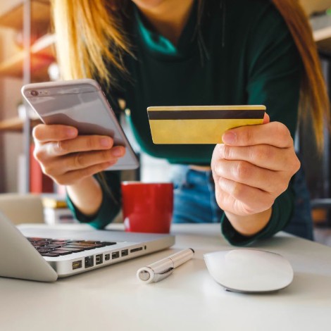 Person holding phone and credit card
