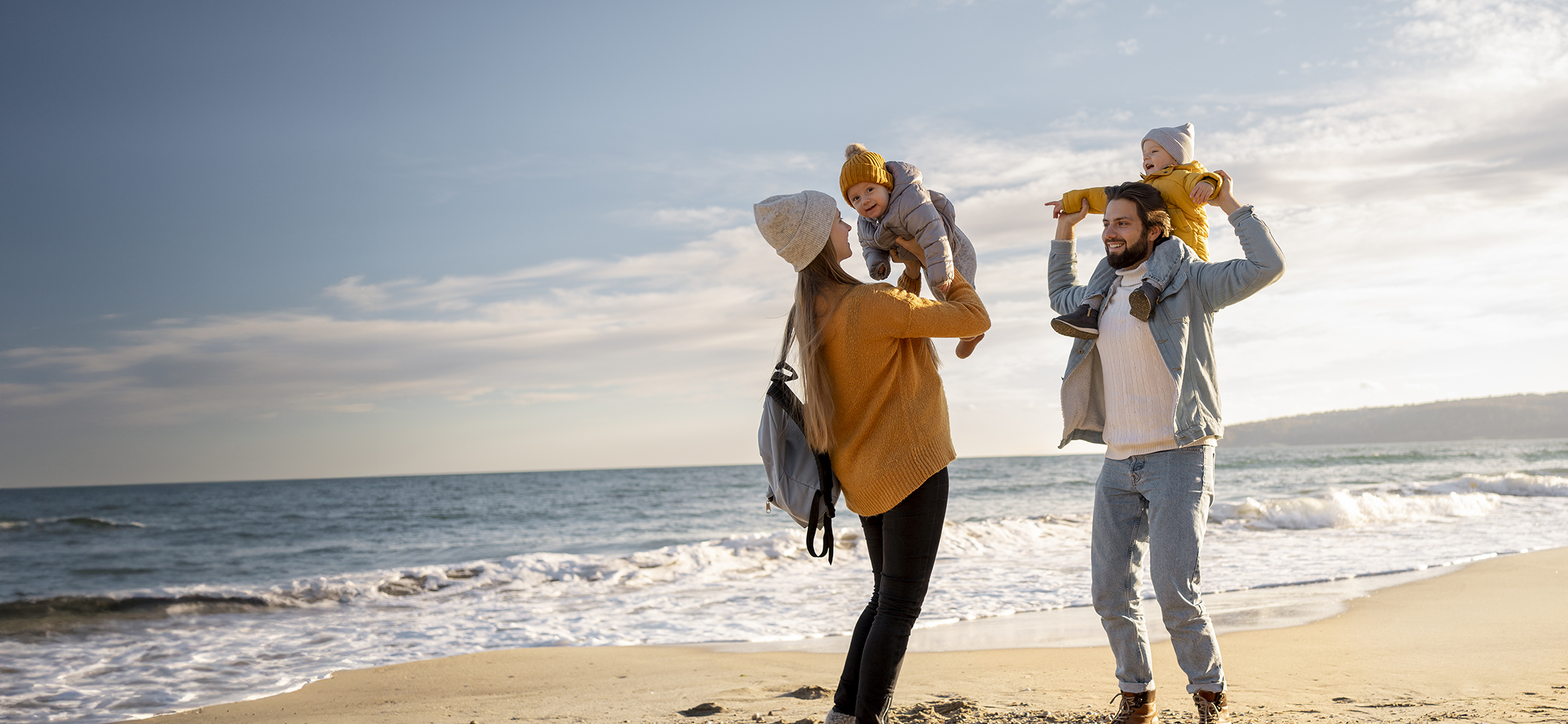 Family running to the beach