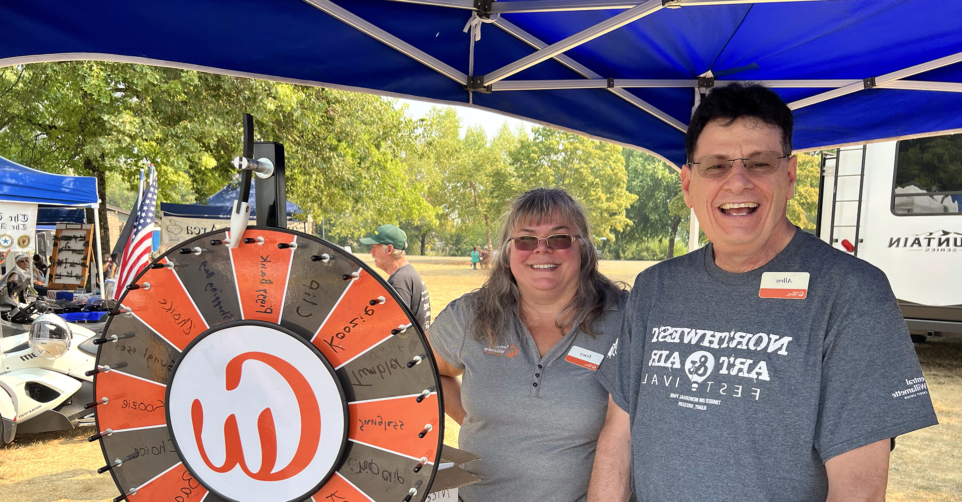 Man and woman spinning CWCU wheel