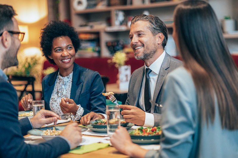 Coworkers eating lunch together