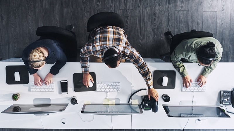 Three people working in an office