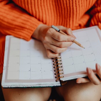 Person looking at calendar on lap