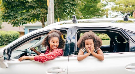 mom and daughter driving in car
