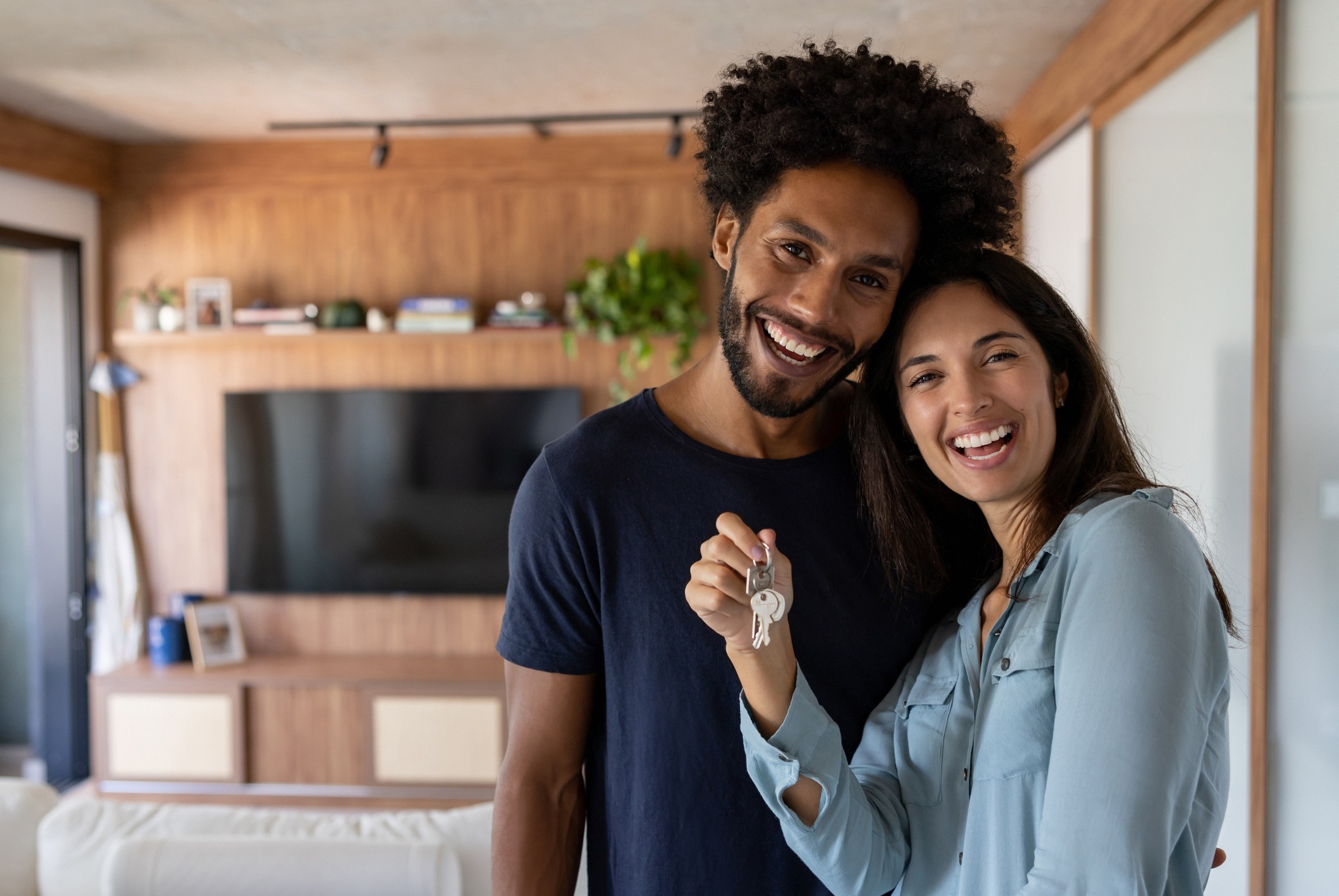 Couple smiling and holding a key